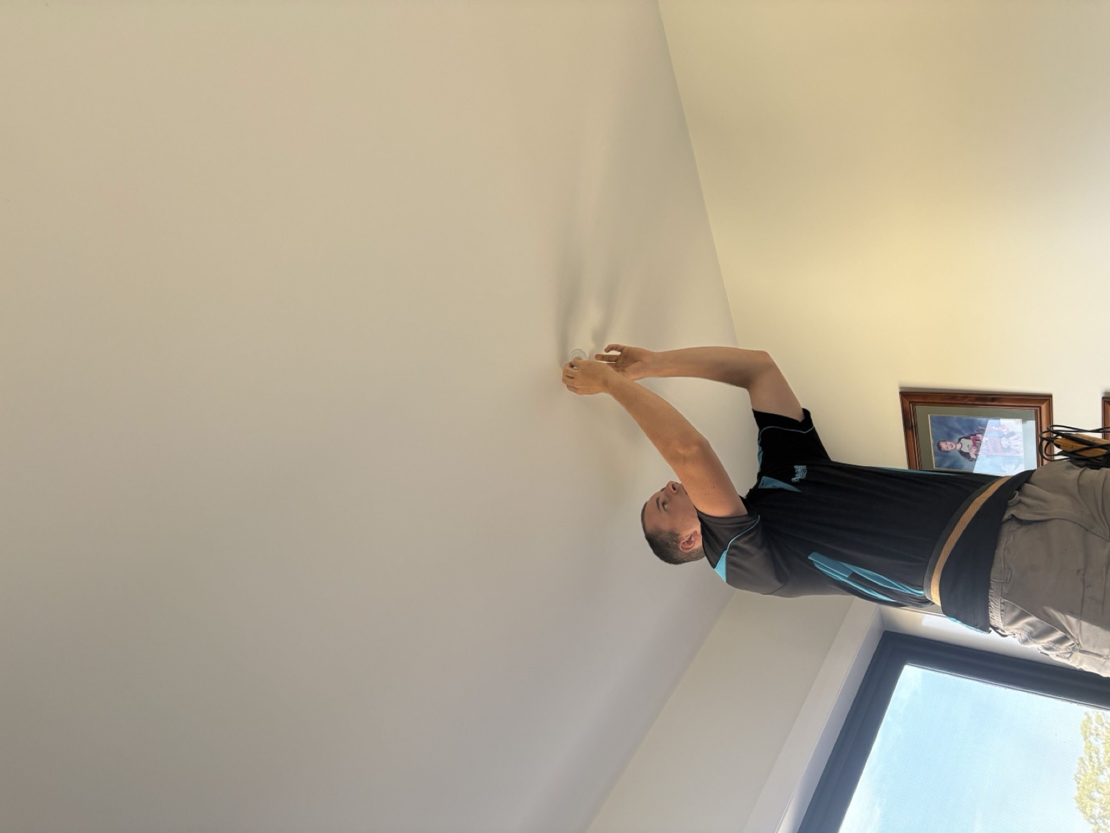 RB Solar & Electrical technician installing a ceiling fitting in a Bendigo home